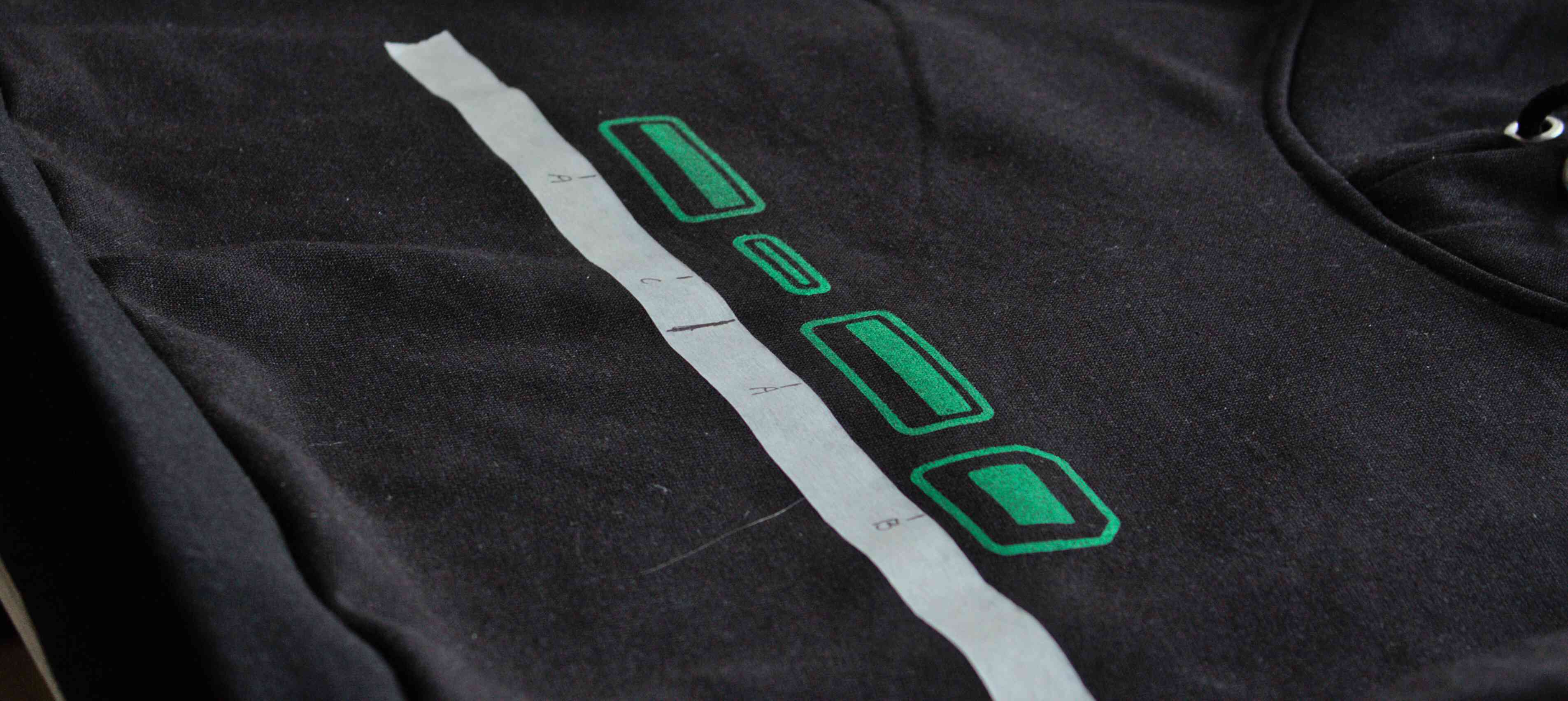 The hoodie with four designs printed on it in green